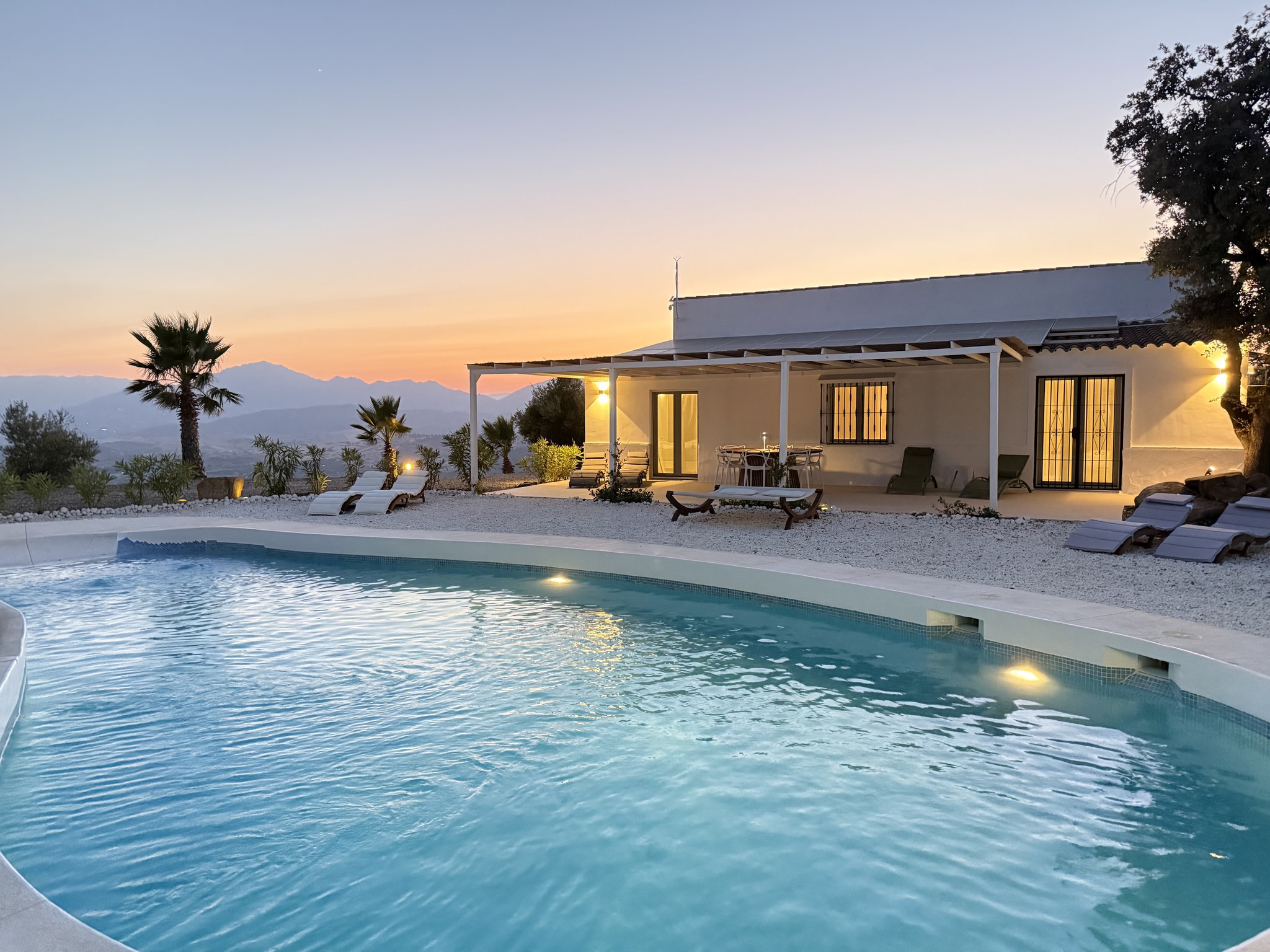Casa Lux private pool and illuminated villa at sunset in Álora, Andalusia