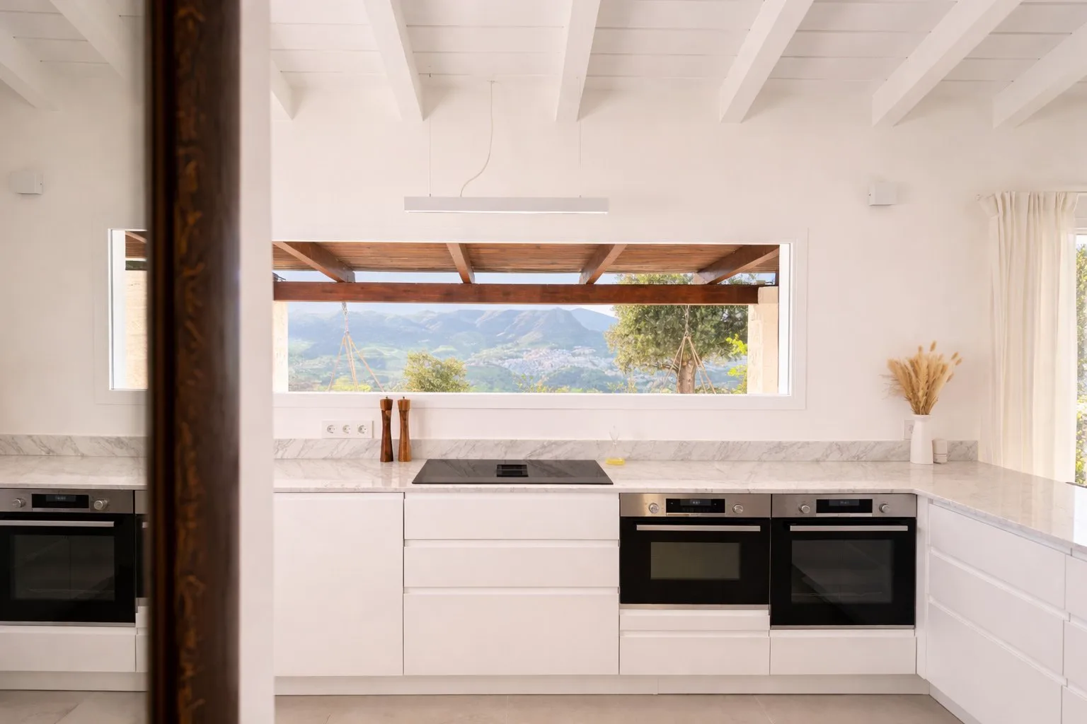Casa Lux kitchen with scenic mountain views over Álora