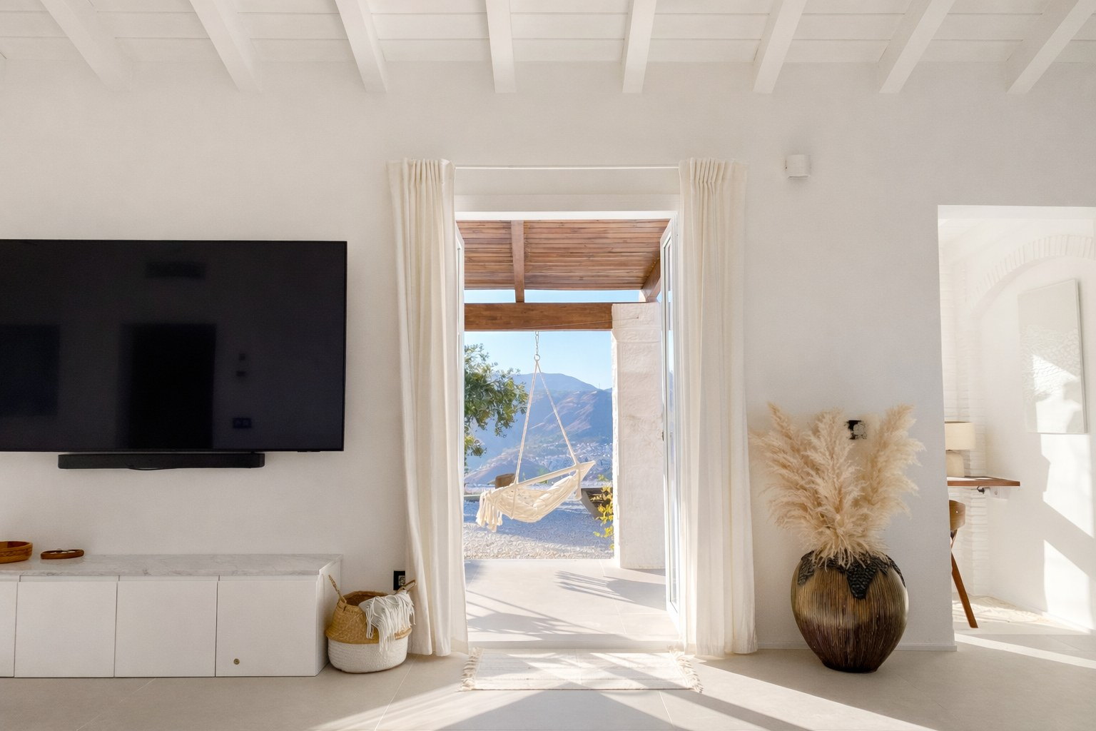 Casa Lux bright living room opening to outdoor terraces and poolside living